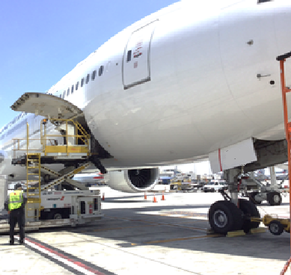 空港のエプロンで、機体前方の貨物扉を開けて地上整備を行っている航空機の様子